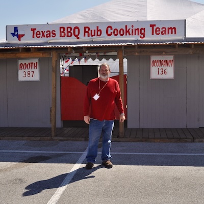 picture of bill cannon in front of bbq booth