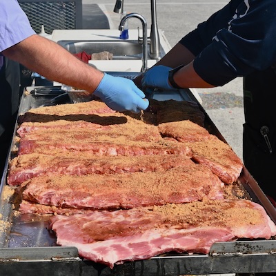 picture of pork spare ribs being rubbed with texas bbq rub